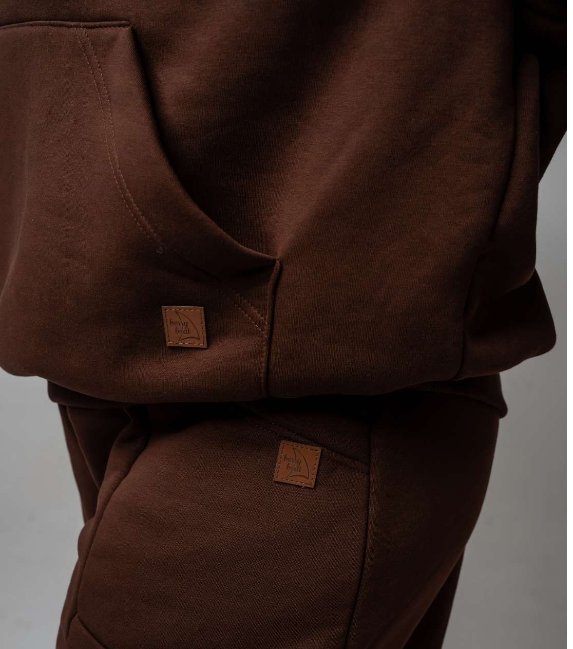 Detalle de sudadera oversize BerryBoat – bolsillo canguro con costuras y etiqueta, color chocolate con leche